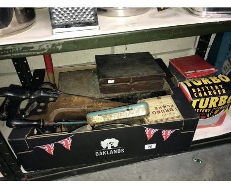 A steel toolbox with tools, including battery charger, saws, electric drill, flood light &amp; some tins