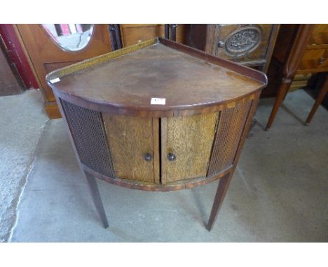 A George III mahogany bow front corner washstand