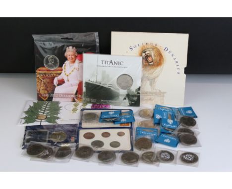 A collection of British coins to include a £1 coin cover, a Royal Mint pre decimal set, Britains First Decimal set, Titanic £