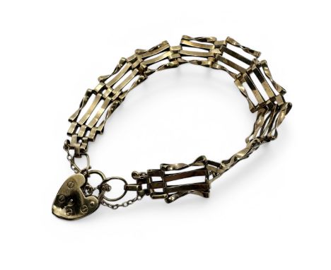 A 9ct gold gate bracelet with a heart padlock and safety chain. Please note the heart padlock is as found due to dent through