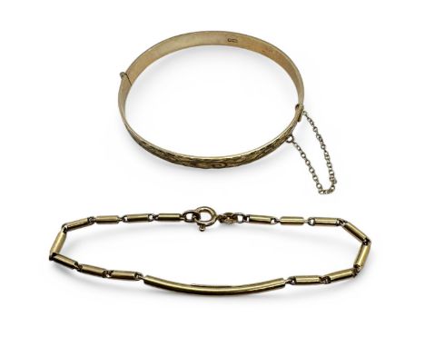 A 9ct gold hinged bangle, together with a 9ct gold identity bracelet, marked "O.P. Orlandini". The hinged bangle is function 
