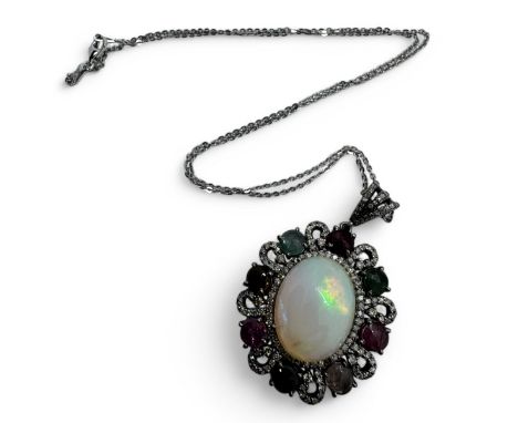 An opal, tourmaline and diamond set pendant in sivler.Featuring a 7ct cabochon of opal, framed by eight multi-colour tourmali