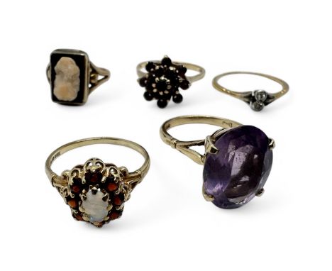 A collection of five gold dress rings. Comprising a 9ct gold amethyst cocktail ring, size O; a 9ct gold opal and garnet dress