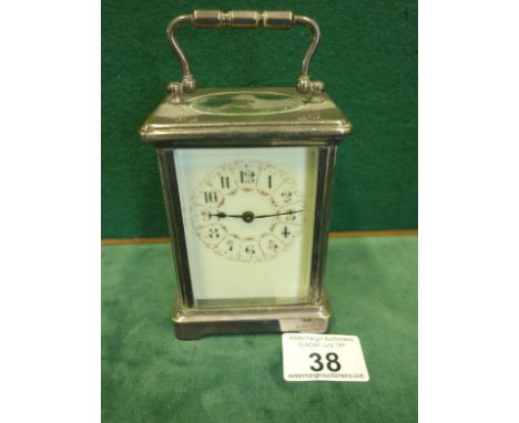 Early 20th century carriage clock with an 8 day movement, enamel painted dial 4.1/4" tall silver coloured body, 4 glass sides