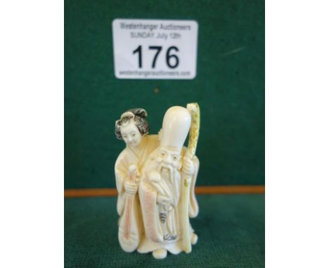 Small carve Netsuke Geisha Girl and long headed Man, highlighted finish with signature to the base you can now bid live on al