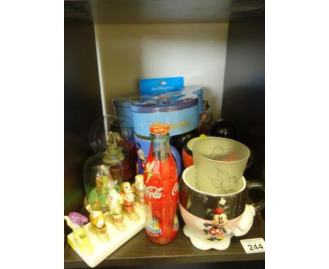 Shelf containing various Disney items some signs of damage including Mickey Mouse egg timer and cups