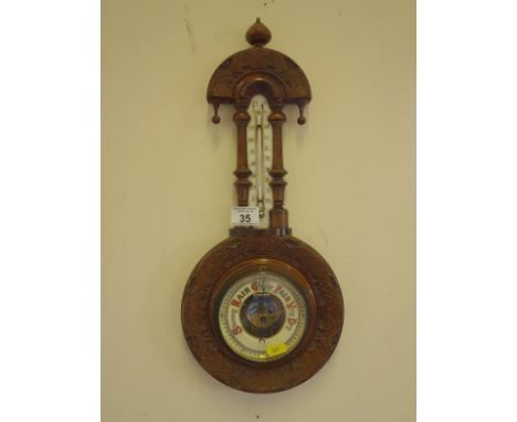 Edwardian period Banjo barometer probably aneroid with temperature aperture and weather aperture, carved mahogany case, 18" l