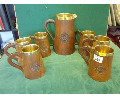 collection of 6 half pint tankards, each with hand carved logo of Frontier Force Rifles and1 large serving water or ale jug e