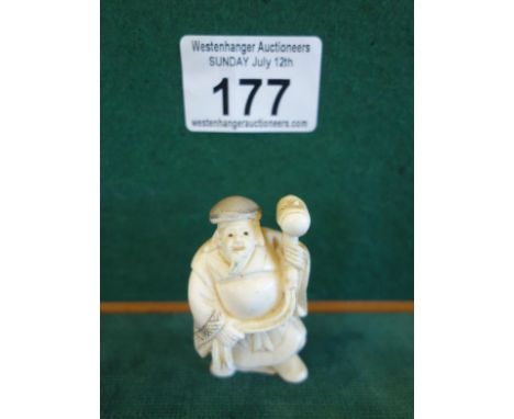 Ivory Netsuke of a Buddha in a Hat holding a hammer, signed to base 2" tall you can now bid live on all our lots via thesaler