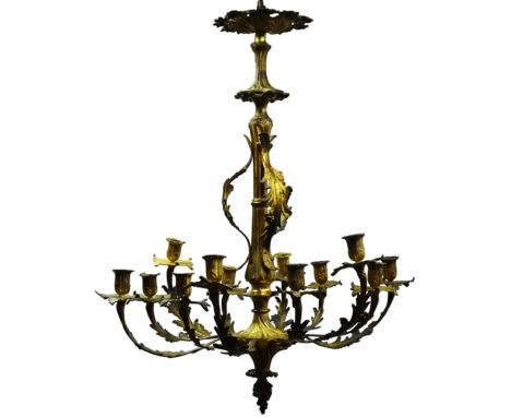 Late 19th century cast gilt metal and ormolu chandelier, the twelve acanthus scroll branches with urn shaped sconces and leaf