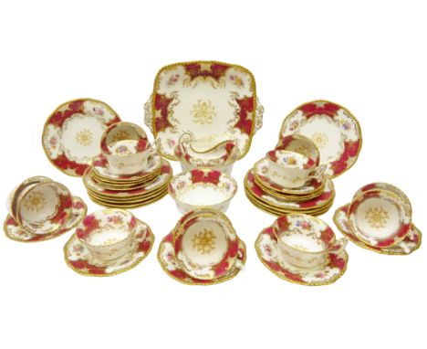 Early 20th century Coalport Batwing red ground tea service comprising twelve tea cups & saucers, eleven plates, milk jug, two