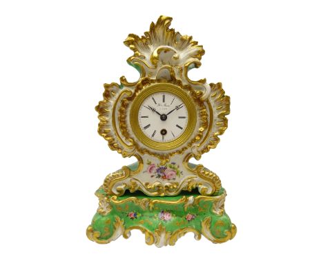 19th century porcelain clock on stand by Jacob Petit, the Rococo cartouche shaped case with gilt scrollwork and painted with 