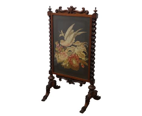 Victorian walnut firescreen with scroll carved cresting, the tapestry panel depicting a parrot and flowers, with barley twist
