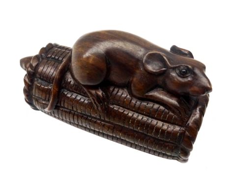 Japanese Meiji boxwood Netsuke carved as a rat perched on top of a rice bail and another rat below, inset with glass eyes, ca