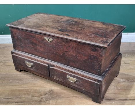 An 18th Century oak Coffer Bach, the lift up lid with replacement hinges, above pair of fitted drawers, raised on shaped brac