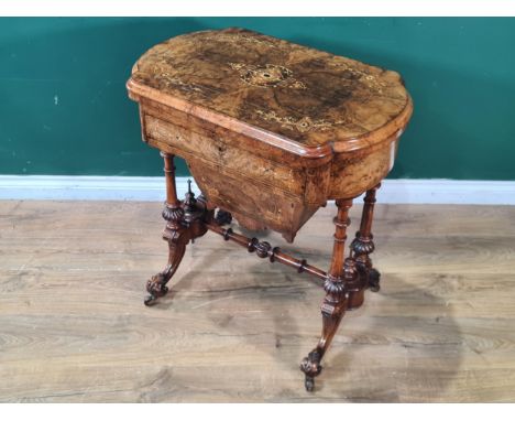 An Edwardian walnut and marquetry Games/Work Table with shaped rectangular fold-over top revealing chequers, cribbage and bac