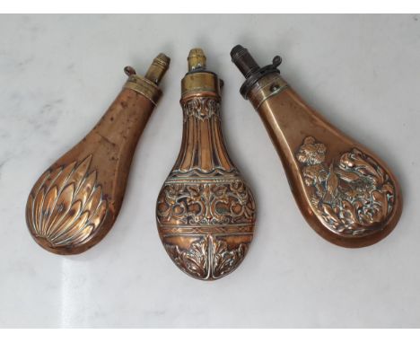 A 19th Century copper Shot Flask by Dixon &amp; Sons with embossed leafage design and two other embossed copper Shot Flasks