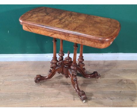 An Edwardian walnut Card Table with satinwood marquetry inlay, having rotating fold-over top, raised on four turned supports 