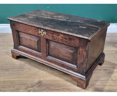 An 18th Century and later oak Coffer Bach, the hinged lid above panelled front, raised on later bracket feet, 1ft 1"High x 2f