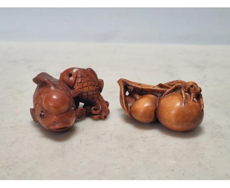 Two carved wood Netsuke in the form of fish and an insect on fruit