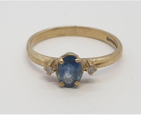 A Sapphire and Diamond three stone Ring claw-set oval-cut sapphire between brilliant-cut diamonds in 9ct gold, ring size K, a