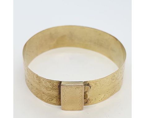 A rigid gold Bangle with bright-cut engraving, approx 12.50gms, unmarked, untested