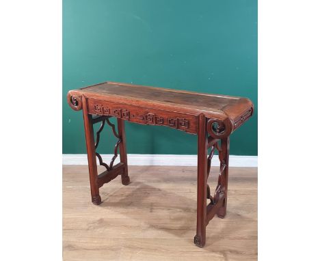 A Chinese hardwood Altar Table with scrolled top above a carved frieze and raised on moulded squared supports, 3ft 8in W x 2f