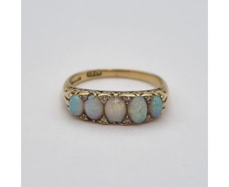 A Victorian five stone Opal Ring pavé-set graduated oval opal cabochons with rose-cut diamond points between, stamped 18ct, r