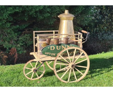 A Victorian three wheeled Dairy Hand Cart, with painted wooden signs inscribed "Dunn, Upton Cross Dairy" with matching brass 