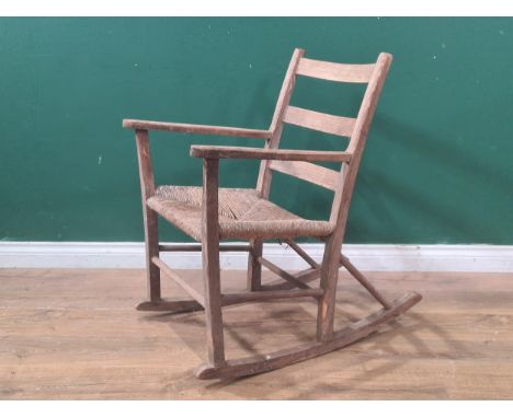 A 19th century Shaker style Rocking Chair with ladder back and rush seat width-22", height-34", Depth-30"