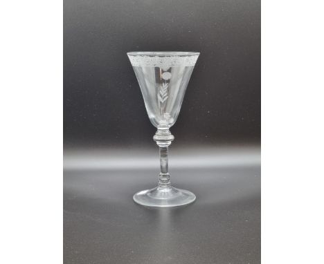 A Newcastle light baluster Trick Wine Glass, the trumpet, shaded bowl engraved band of flowers and scrolled branches, some wi