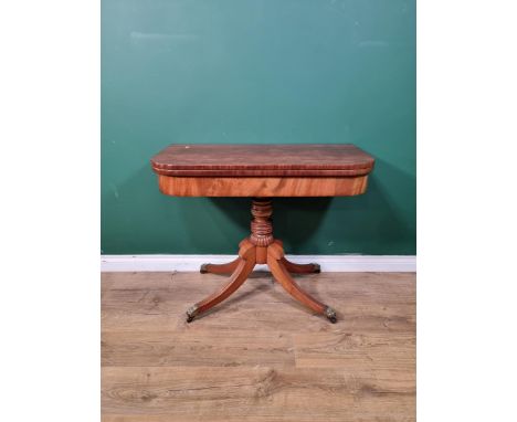 A Regency mahogany card Table with D-shape fold-over top on turned and fluted column with quadruple splay base having brass t