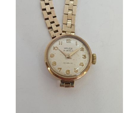 A lady's vintage Majex Wristwatch the champagne enamel dial having applied gold Arabic numerals in 9ct gold case, case width 