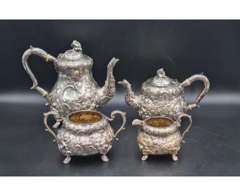 A Victorian silver four piece Tea & Coffee Service with floral and scroll embossing, engraved initials on stylised paw feet, 