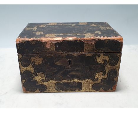 An 18th Century paper covered Tea Caddy with Chinese style gilded design of buildings in landscape, the hinged lid enclosing 