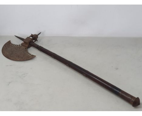A Indian axe, circa mid 19th century, the head with chiselled designs on each side, the socket formed as a shrine or turret. 