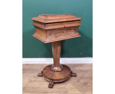 An early 19th Century rosewood Teapoy of sarcophagus shape having two interior lidded compartments on octagonal column with c