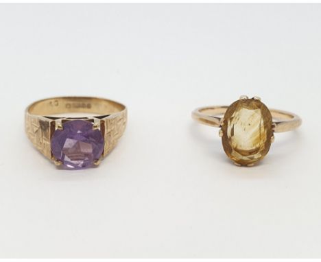 An Amethyst Ring claw-set round stone in 9ct gold, ring size L 1/2 and a Citrine Dress Ring set oval-cut stone, ring size K, 