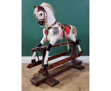 An antique carved wooden Rocking Horse of small proportions, 29" H and 32" L