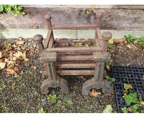 A pair of large iron Fire Dogs and a basket Grate