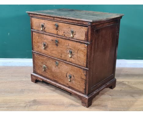 An 18th Century oak Chest of three long drawers with satinwood stringing raised on bracket feet 2ft 6in W x 2ft 5in H