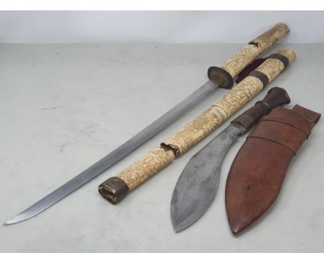 An antique Japanese Wakizashi with carved bone grip and scabbard A/F 25 1/2in L overall and a Kukri in leather scabbard