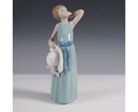 This Lladro figurine, titled "Prissy" (1005010), showcases the brand's signature elegance with a delicate depiction of a youn