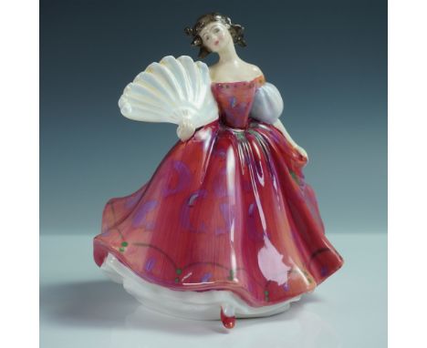 This Royal Doulton figurine, titled First Waltz (HN2862), portrays a graceful young woman in an elegant flowing gown, delicat