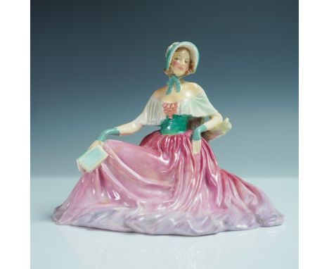 A Royal Doulton porcelain figurine titled Memories, model number HN1855. Designed in a classic seated pose, this figurine fea