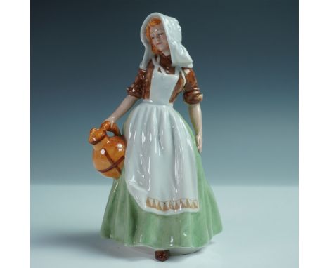 This hand-painted porcelain figure depicts a young woman in traditional rural attire, carrying a brown earthenware jug. She w