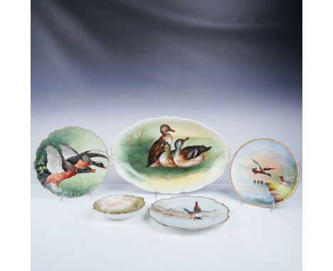 This lot features five Limoges china plates and bowls, each exquisitely hand-painted with bird and game scenes, signed by var