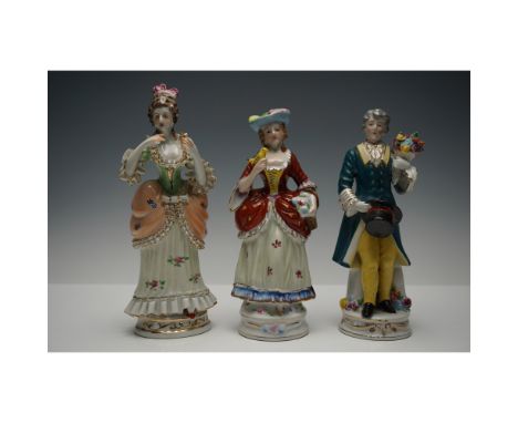 A delightful trio of hand-painted porcelain figurines, including two pieces marked "Occupied Japan". These figures depict ele