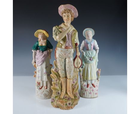 A charming 3-piece set of hand-painted porcelain figurines, crafted in Occupied Japan. This set features a pastoral scene wit