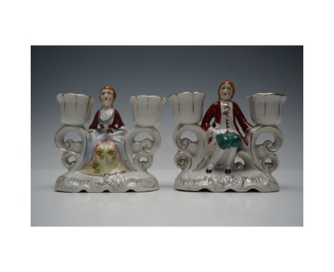 A charming pair of porcelain figural candle holders marked "Made in Occupied Japan", dating from the post-World War II period